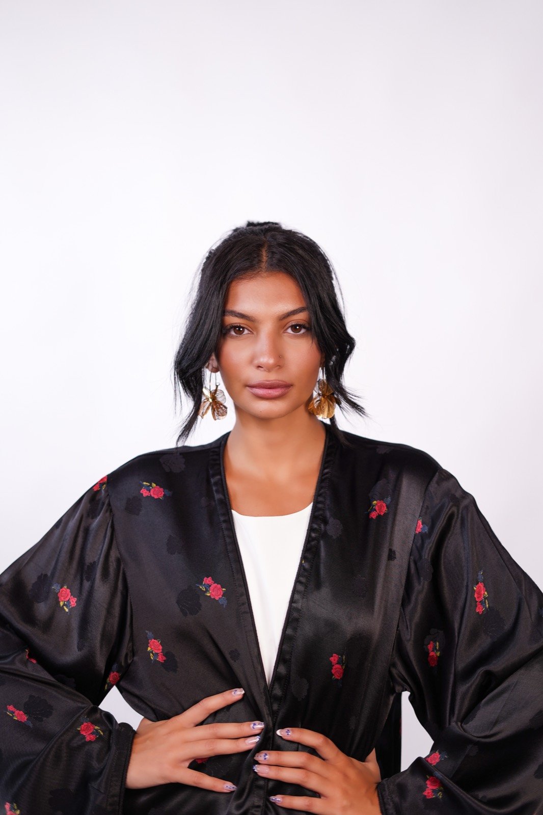 Scarlet Whisper open-front robe in black with small red flowers, waist-up, showing the print, from the Le Kanz summer collection